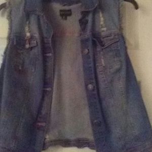 Distressed sleeveless denim jacket